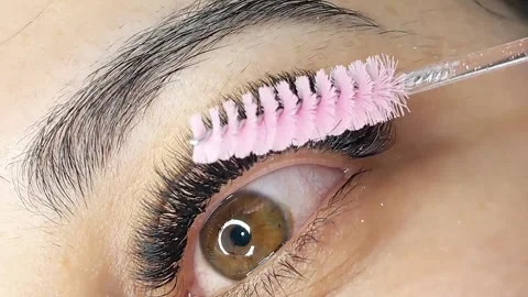 Close up of female eye with eyelash extensions in beauty salon Stock Footage 329012155