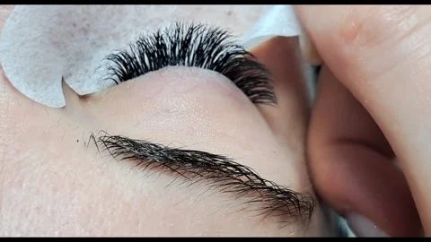 Close up of female eye with eyelash extensions in beauty salon Stock Footage 329012163
