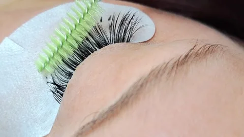 Close up of female eye with eyelash extensions in beauty salon Stock Footage 329012182