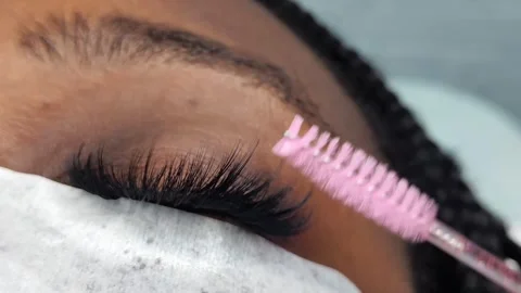 Close up of female eye with eyelash extensions in beauty salon Stock Footage 329012183