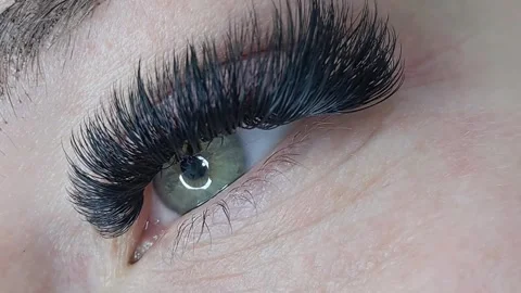 Close up of female eye with eyelash extensions ,eyelash extension procedure Stock Footage 329742779