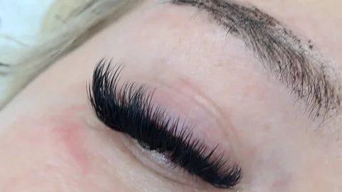 Close up of female eye with eyelash extensions ,eyelash extension procedure Stock Footage 329742786