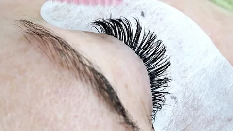 Close up of female eye with eyelash extensions ,eyelash extension procedure Stock Footage 329742789