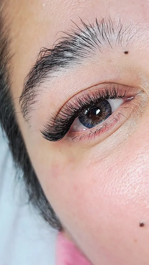 Close up of female eye with eyelash extensions ,eyelash extension procedure.2 Stock Footage 340830415