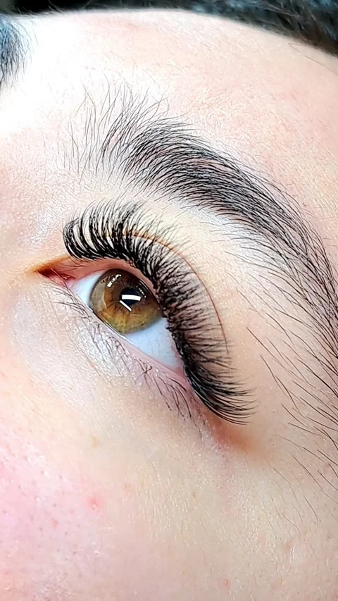 Close up of female eye with eyelash extensions ,eyelash extension procedure.2 Stock Footage 340830419