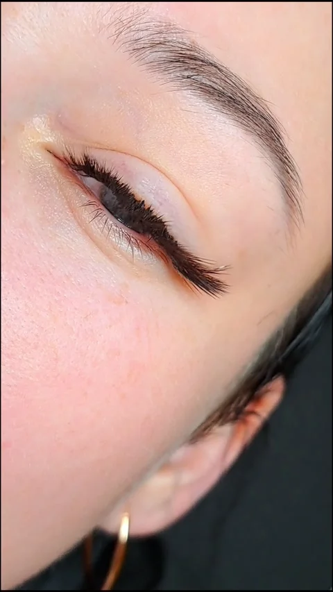 Close up of female eye with eyelash extensions ,eyelash extension procedure.2 Stock Footage 340830425