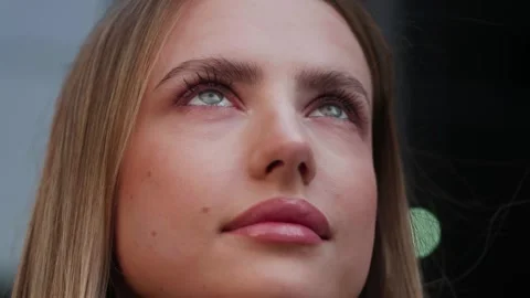 Close up of female face. Authentic candid real woman outside in nature or on Video stock 242712589