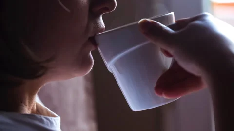 Close up of female face drinking coffee from white cup. Full HD RAW video Stock Footage 58691641