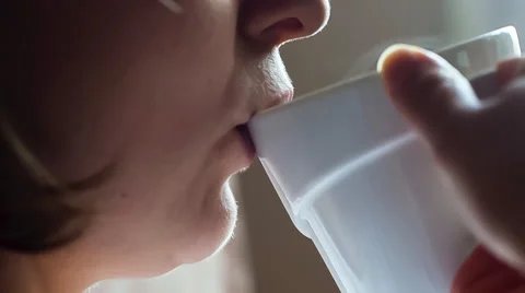Close up of female face drinking coffee from white cup. Slow motion Stock Footage 58691704