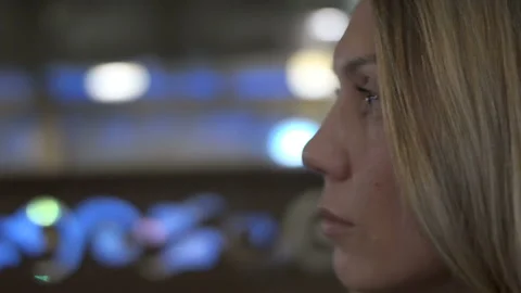 Close-up of a female face looking forward to a cafe in the evening Stock Footage 86207320