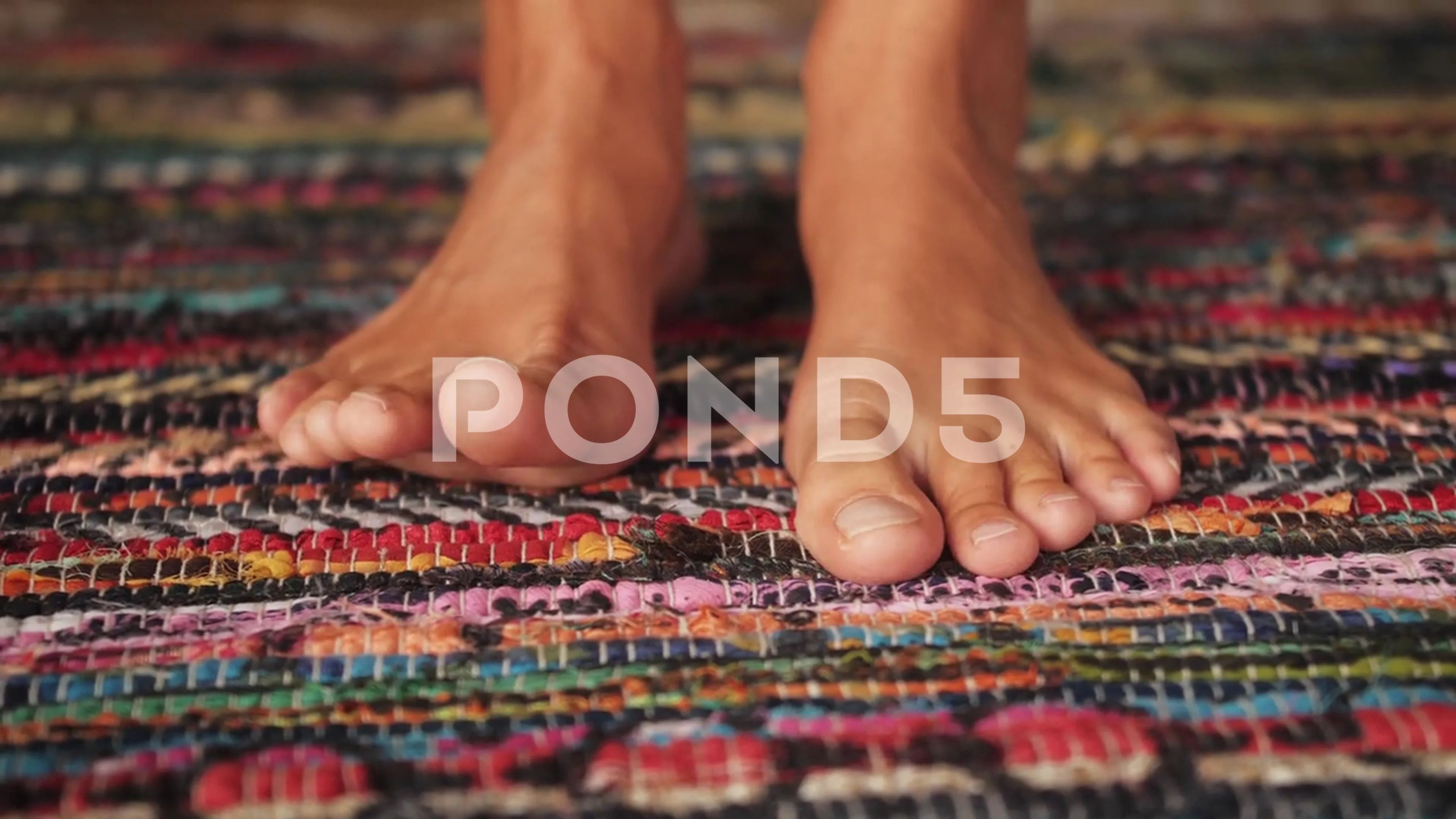 Close-up of female feet moving toes. Barefoot girl on fluffy soft carpet in