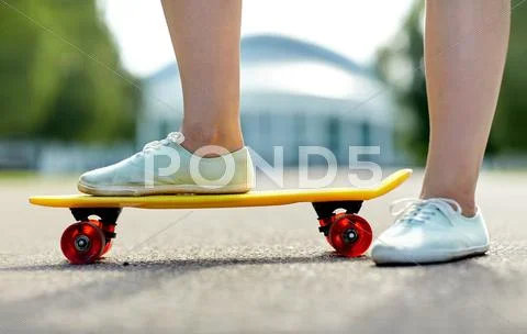 Close up of female feet riding short skateboard Stock Photos