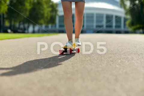 Close up of female feet riding short skateboard Stock Photos