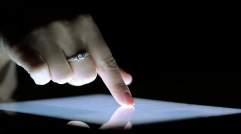 Close-Up of Female Finger on the Ipad Screen in the Dark Stock Footage 59147733