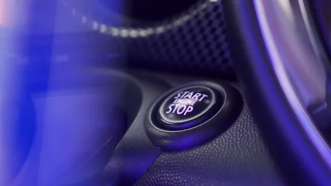 Close up of female finger pressing an engine start stop button on modern Stock Footage 118964409