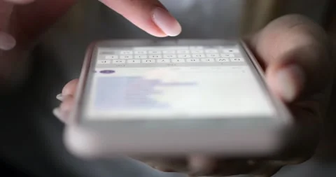Close-up of female fingers typing a message on a mobile phone. Stock Footage 143966912