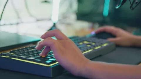 Close Up Of Female Gamer Using Computer Keyboard And Mouse For Live Stream Stock Footage 220590366