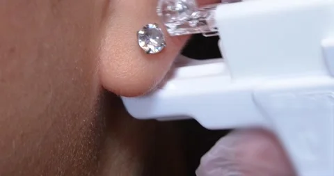 Close up female getting her ears pierced by a professional  Video stock 285294534