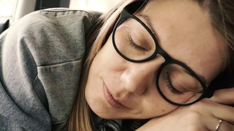 Close-up of a female in glasses looking into the camera with a smile Stock Footage 76010721