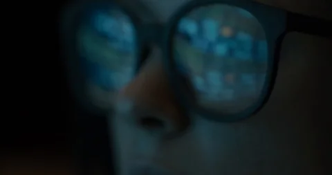 Close-up female in glasses reflecting mining cryptocurrency process Stock Footage 98688549