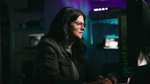 Close Up Of Female Hacker Or Cyber Criminal Working In Front Of Computer Screens Stock Footage 276229867