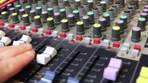 Close-up of female hand adjusting knobs on old analog mixer Stock Footage 170389398