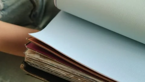 Close up of a female hand browsing fabric samples to choose material for roller Stock Footage 346741493