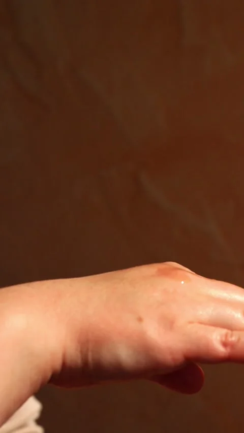 Close up of female hand carefully dropping aromatic body oil with glass pipet Stock Footage 311040554