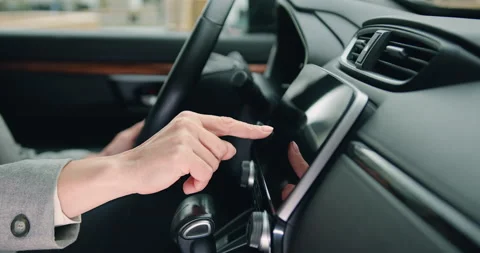 Close up of female hand driver entering an address into the navigation system in Stock Footage 196987840