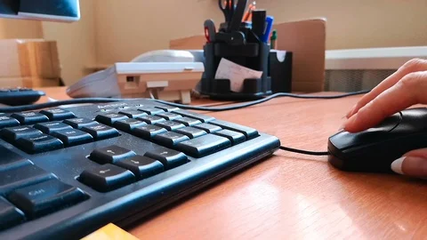Close-up: female hand is holding a computer mouse Stock Footage 103855253