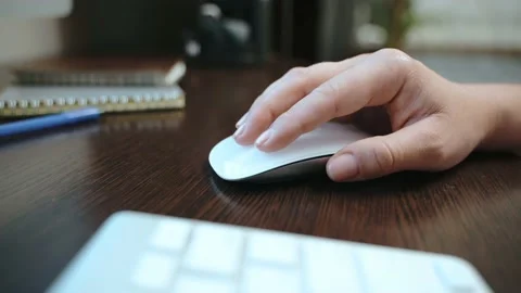 Close-up of a female hand holding a computer mouse. Stock Footage 213206097