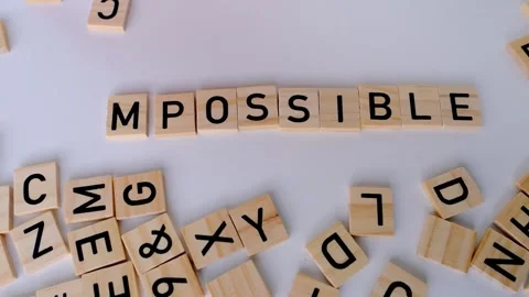 Close-up female hand holds square wooden alphabet blocks, word impossible t.. Stock Footage 248553818