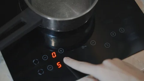 A close-up of a female hand includes an electric stove Stock Footage 103206867