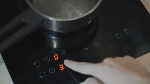 A close-up of a female hand includes an electric stove Stock Footage 103206874