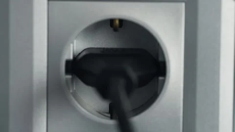 Close-up of a female hand inserting the plug of an electrical appliance into a 스톡 동영상 315285461