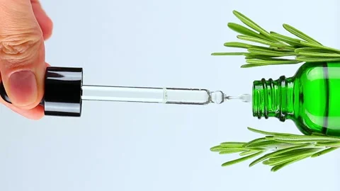 Close-up of female hand lifts dropper lid, oily drops fall from cosmetic pipette Stock Footage 169755053