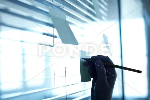Close-up of female hand making note for work Stock Photos