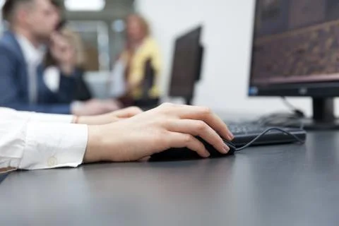 Close up of female hand on mouse while typing on keyboard Stock Photos