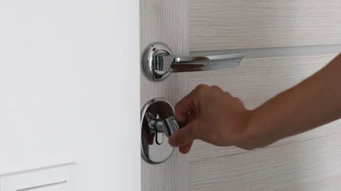 Close up female hand opens white wooden door in white room. Stock Footage 255590685