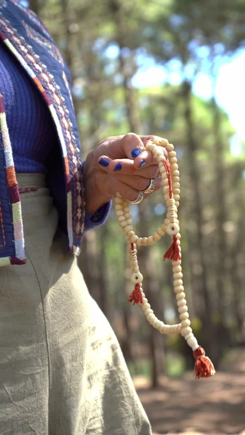 Close-up of female hand praying while holding a japa mala Video stock 252773133