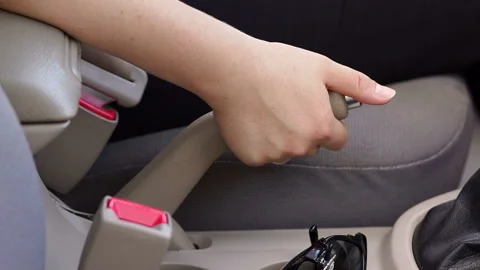 Close-up of female hand pulling handbrake lever in the car. Stock Footage 95590205