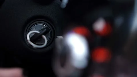 Close-up. Female hand pulls keys out of ignition, panel buttons turn off 4K Slow Stock Footage 100398387