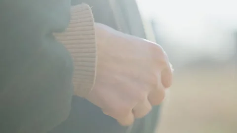 Close up of female hand with red nails pulling zipper of dark wool coat Stock Footage 320336785