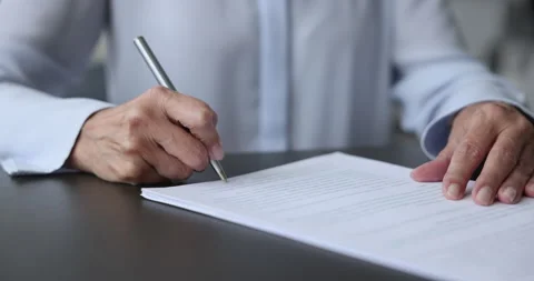 Close up of female hand signing document or application form Stockbeeldmateriaal 237324656