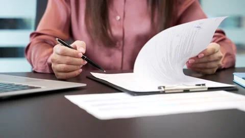 Close-up of female hand signing documents at desk in office. Businesswoman  스톡 동영상 332850011