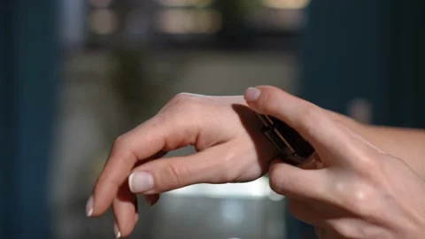 Close-up female hand squeezing makeup base on palm skin in slow motion Stock Footage 221864239