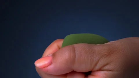 Close up of female hand squeezing makeup sponges, beauty blending sponge Stock Footage 245004500