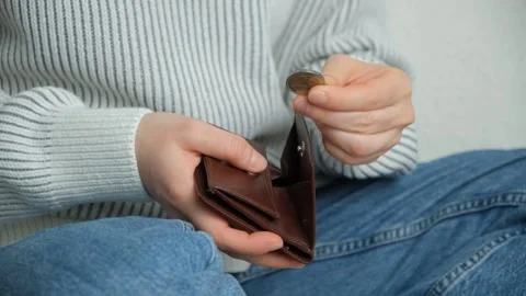 Close up of female hand taking a 2 euro coin from a leather wallet Stock Footage 335228928