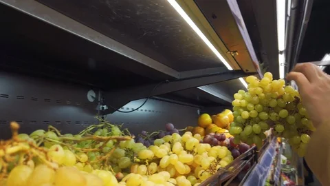Close-up female hand taking grape from refrigerator in super market. High resolu Stock Footage 119637535