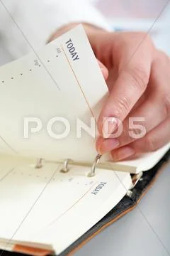 Close-up of female hand turning page of notepad Stock Photos